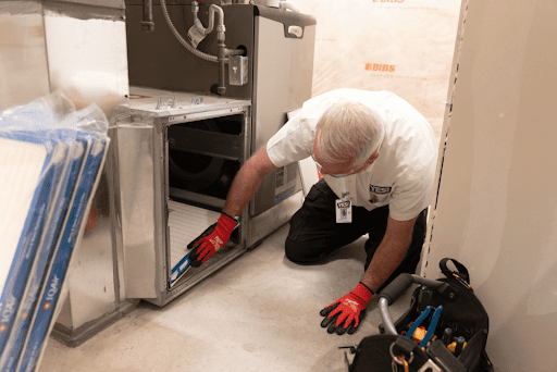 HVAC tech replacing a furnace filter