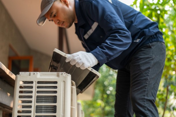 Technician performing HVAC service in Hurricane Utah